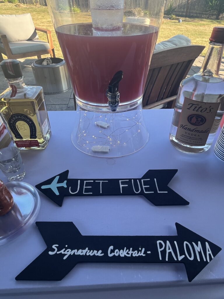Signature cocktail bar labeled Jet Fuel with a Paloma punch dispenser
