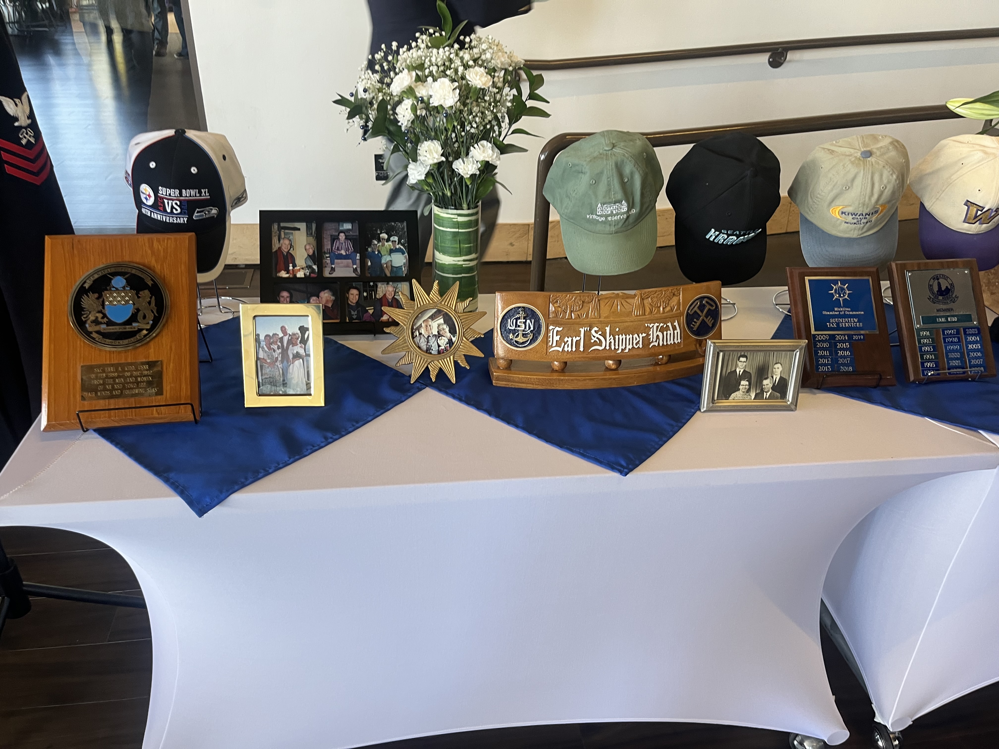 Memory display with photographs and floral arrangements
