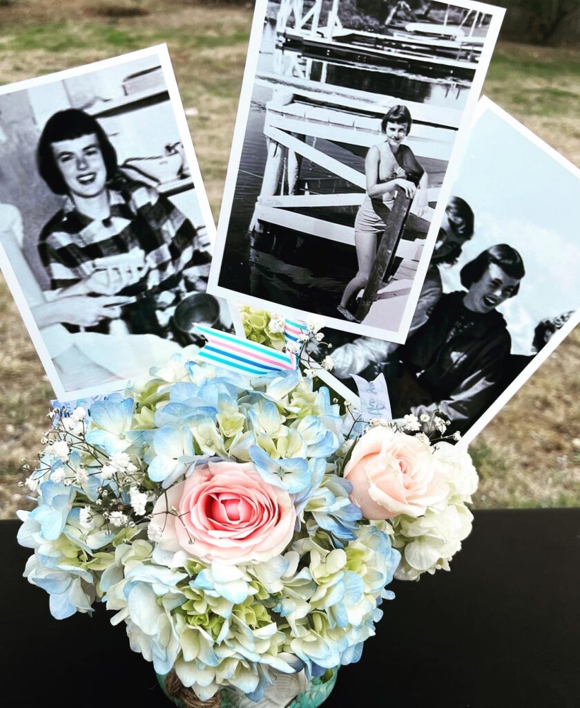 Blue hydrangea floral arrangement with vintage black and white portrait photos tucked in