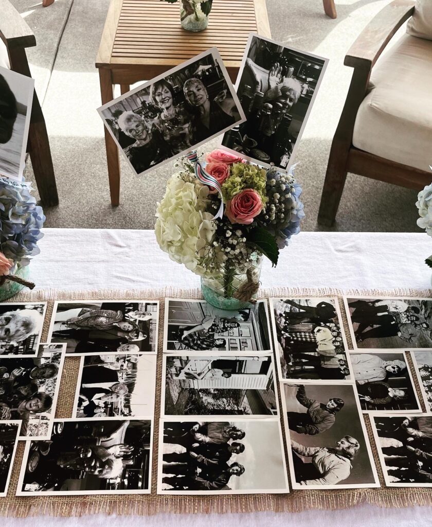 Floral memorial display with framed portrait and candles