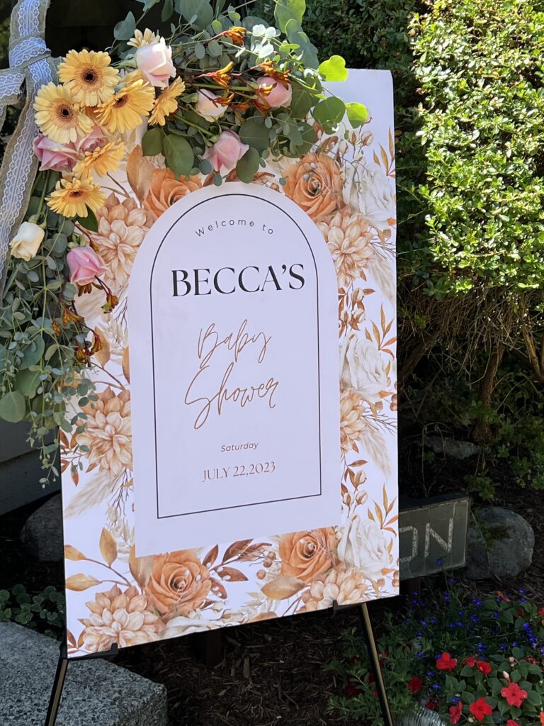 Becca's Baby Shower welcome sign with floral arch